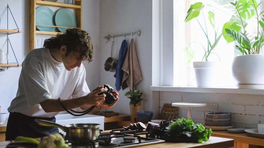 A freelance home-cook tester in her apartment kitchen with a printed recipe card.