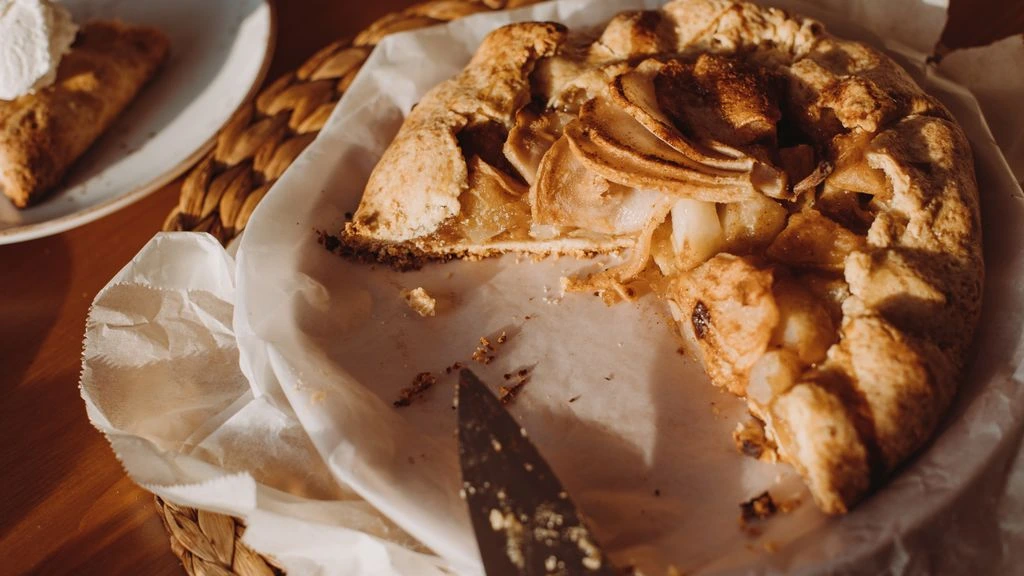 Late-summer tomato galette on a baking sheet