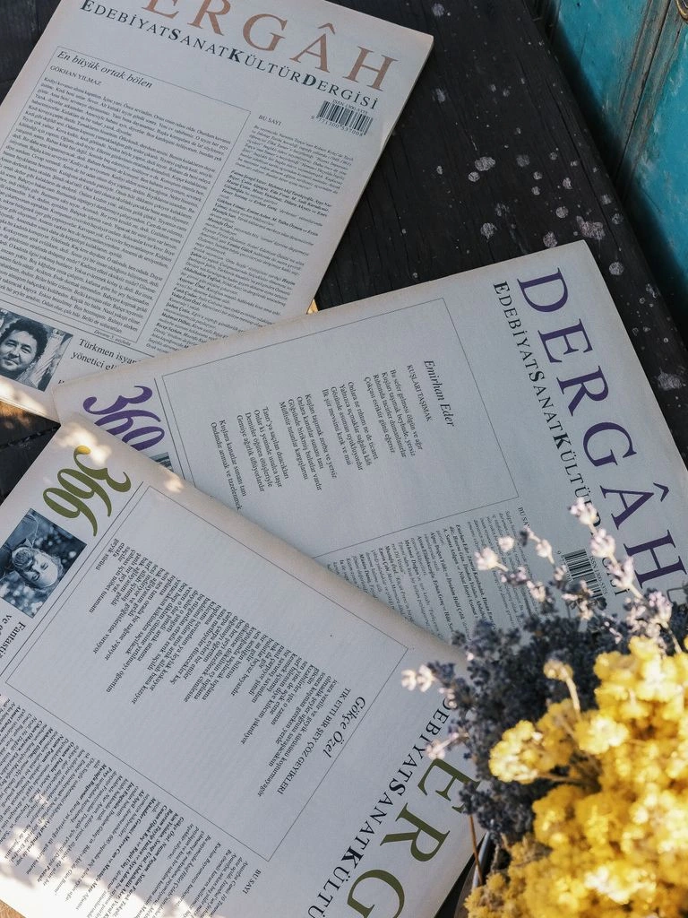 Cover of The Kitchen Table Journal, Winter 2024 issue, featuring a sprig of rosemary on warm cream paper